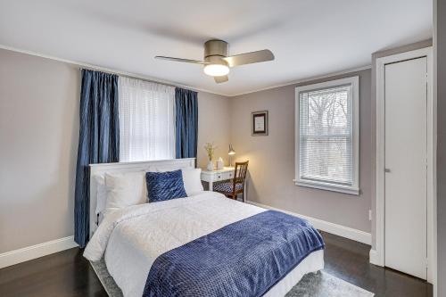 a bedroom with a bed and a ceiling fan at Modern Terryville Cottage with Deck and Lake View! in Terryville