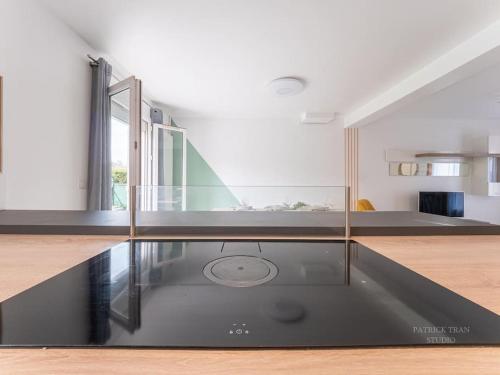 a living room with a glass table in the middle at Spacious & Modern Property - between Disney & Paris - close to transportation, highway, amenities in Saint-Thibault-des-Vignes