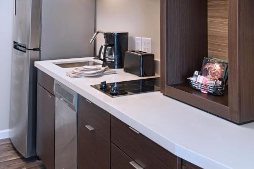 a kitchen with a counter top and a refrigerator at TownePlace Suites by Marriott Lakeland in Lakeland