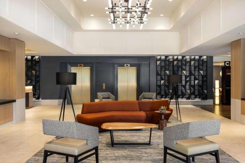a living room with a couch and two chairs at Hilton Vancouver Airport in Richmond