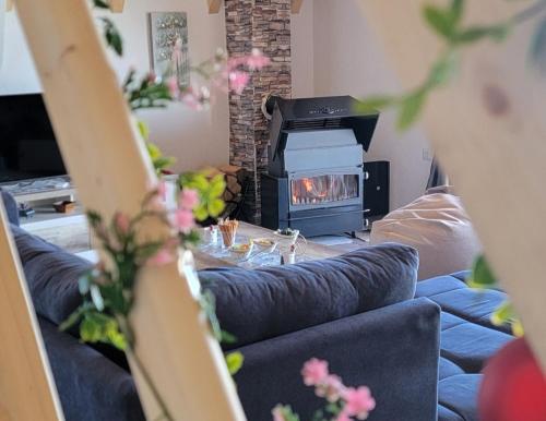 a living room with a couch and a fireplace at Kuća za odmor Villa Kovačević in Bihać