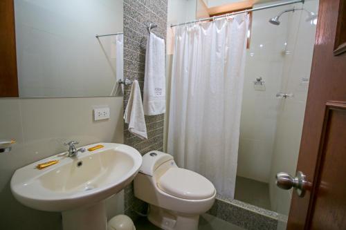 a bathroom with a sink and a toilet and a shower at El Chasqui in Ollantaytambo