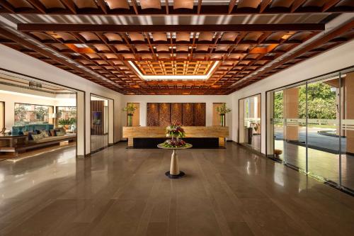 a lobby with a reception desk in a building at Radisson Blu Resort & Spa Alibaug in Alibaug