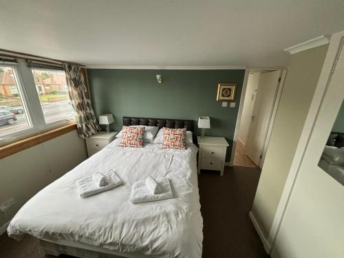 a bedroom with a bed with two towels on it at Netherby Guest House in Edinburgh