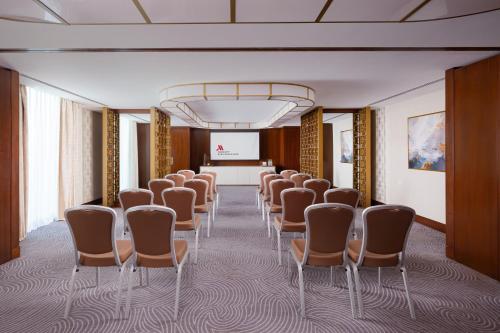 a room with a row of chairs and a projection screen at Baku Marriott Hotel Boulevard in Baku