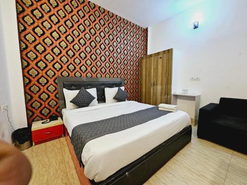 a bedroom with a large bed and a red wall at Hotel AELA Suites "Cloud plaza" near Delhi airport in New Delhi