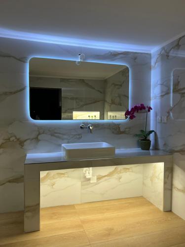 La salle de bains est pourvue d'un lavabo et d'un miroir. dans l'établissement Afiartis Avli House, à Karpathos