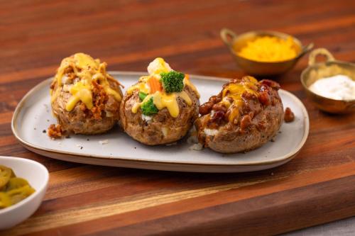four muffins with cheese and broccoli on a plate at Drury Plaza Hotel Chattanooga Hamilton Place in Chattanooga