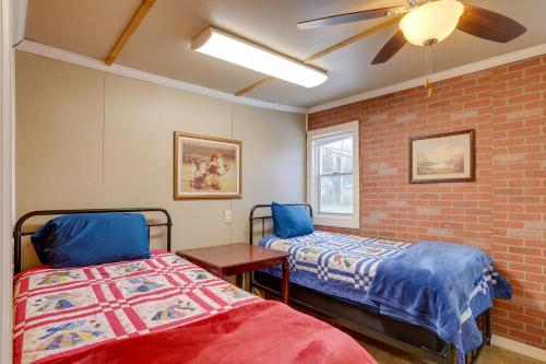 a bedroom with two beds and a ceiling fan at Historic Hardy Home with Game Room on Main Street in Hardy