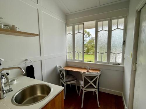 a small kitchen with a sink and a window at Abbey Boutique Hotel Adults only in Warwick