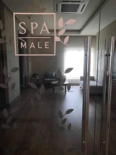 a living room with a sign that reads spam make at Saint Honore Executive: 6 guests, 5 beds, 2 bedrooms, 2 bathrms in Iloilo City