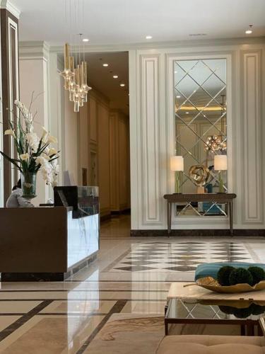 a lobby with a chandelier and a table in a building at Saint Honore Executive: 6 guests, 5 beds, 2 bedrooms, 2 bathrms in Iloilo City