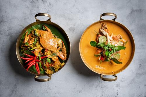 two plates of food sitting on a table at The Ritz-Carlton, Kuala Lumpur in Kuala Lumpur