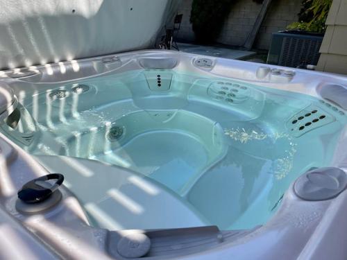 a jacuzzi tub with blue water in it at Walk To Disneyland, Watch Firework Front Yard, SPA in Anaheim