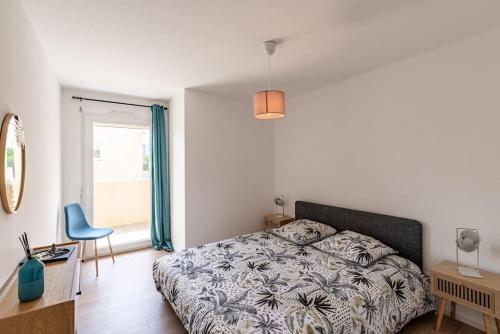 1 dormitorio con cama, escritorio y ventana en ISLA T3 à 150 m de la plage, en Calvi