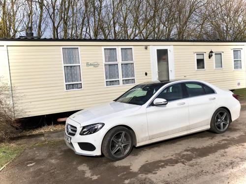a white car parked in front of a house at Southview cedar bank 6 in Skegness