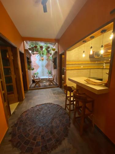 a kitchen with a table and stools in a room at Keur Marieme in Dakar