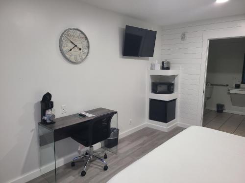 a room with a desk and a clock on the wall at Blue Sky Inn- Complimentary Happy Hour Th-Sun, Veteran owned, Full Breakfast, Best green space, 1 mile from Blue Ridge, Fire Pit in Blue Ridge