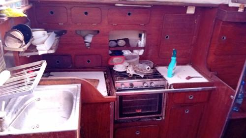 an rv kitchen with a stove and a sink at Joli voilier de 13m in Les Trois-Îlets