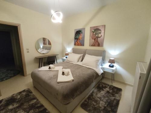 a bedroom with a bed with two towels on it at Sunset View in Ioannina