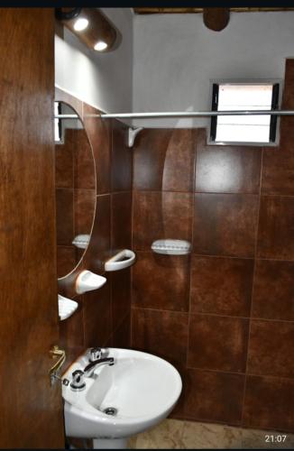 een badkamer met een wastafel en een spiegel bij Flor de los andes in Fiambala