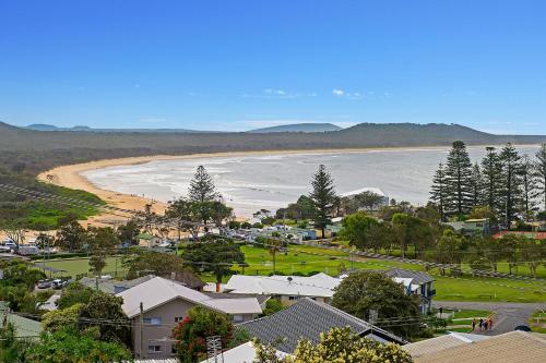 a view of a town with a beach and houses at Barrels Beach House, 28 Dulconghi Street in Crescent Head