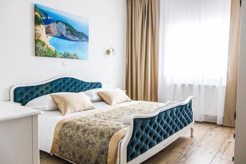 a bedroom with a bed with a blue headboard at Holiday house with a swimming pool Lecevica, Zagora - 22829 in Lećevica