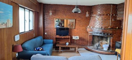 a living room with a brick wall with a fireplace at Casa Medina albaycin Amazing House for 5pax in Granada