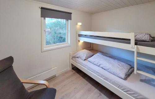 a bedroom with two bunk beds and a window at Gorgeous Home In Jrpeland With House Sea View in Jørpeland