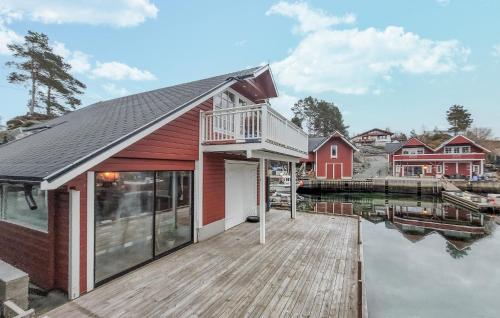 a house on the water with a dock at 3 Bedroom Cozy Home In Lepsøy in Lepsøy