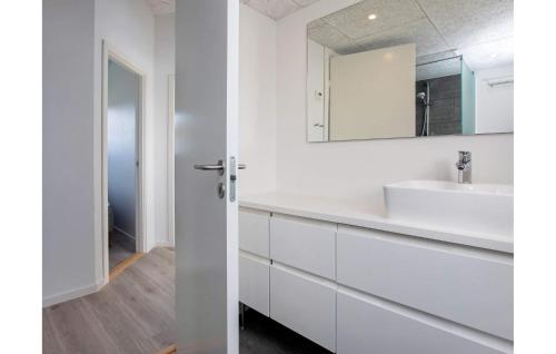 a white bathroom with a sink and a mirror at Amazing Home In Vejby With Kitchen in Vejby