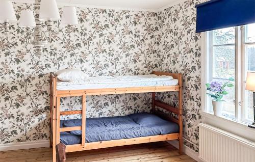 a childs bunk bed in a room with floral wallpaper at 5 Bedroom Lovely Home In Ruda in Ruda