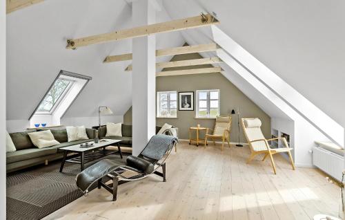 a living room with a couch and a table at 5 Bedroom Gorgeous Home In Bjørnø in Bjerne