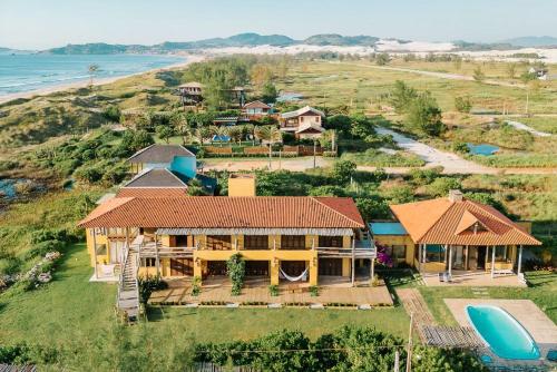 an aerial view of a house on a hill next to the ocean at Kahuma in Imbituba