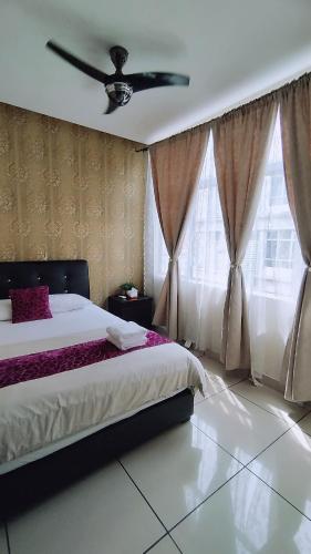 a bedroom with a bed and a ceiling fan at Mimilala Hotel @ i-City, Shah Alam in Shah Alam