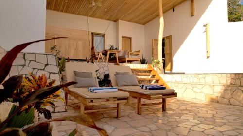 a patio with two chairs and a wooden table at Akasha Beach Club in Bulukumba