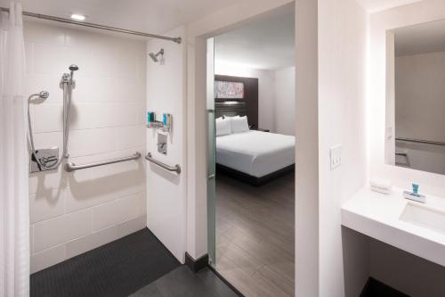 サニーベールにあるアロフト サニーベールのベッドとバスルーム付きのホテルルームです。