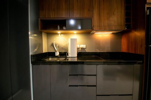 a kitchen with a sink and a counter top at Escape Condominiums Beachfront Suites - Mae Phim in Rayong