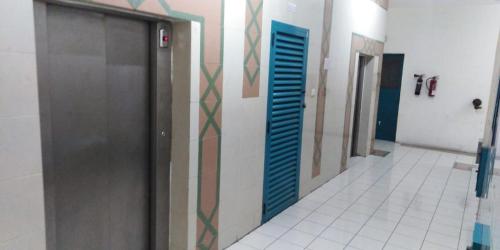 a hallway of a bathroom with a door and a tile floor at قصر الماسه in Sharjah