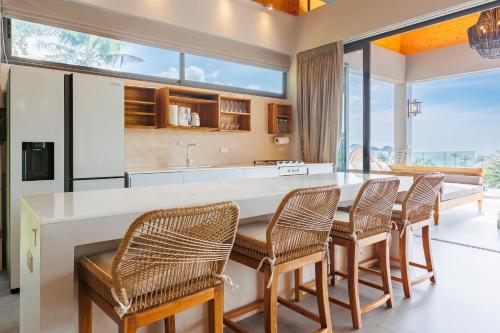 a kitchen with a large white table and chairs at 5Bedrooms Villa Hinkong Bay Koh Phangan in Ko Phangan