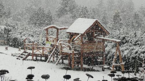 a playground covered in snow in a park at Le Bouquet Apart Hotel in San Carlos de Bariloche