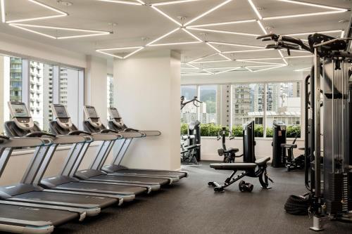 a gym with treadmills and elliptical machines at The Ritz-Carlton Residences, Waikiki Beach Hotel in Honolulu