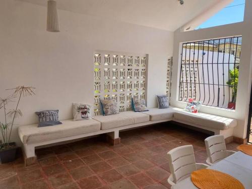 a living room with a bench and a window at Alojamiento Samanà in Santa Bárbara de Samaná
