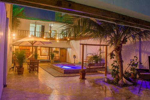 a house with a swimming pool and a palm tree at Room in Guest room - Hb8 Quadruple Room with shared bathroom in Cartagena de Indias