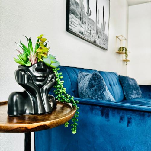 a black statue on a table next to a blue couch at Stylish Hollywood Blvd. w/ FREE Parking in Los Angeles