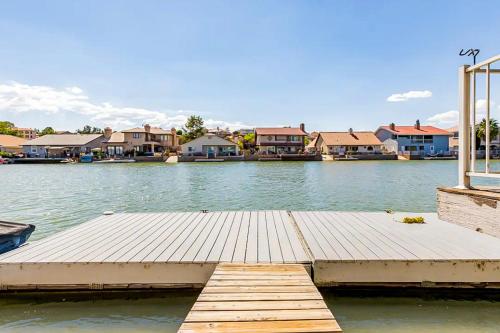 a dock in the middle of a lake with houses at Lake Life Home in Victorville