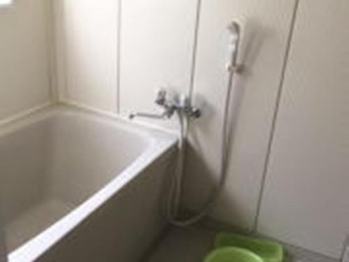 a bathroom with a shower and a tub and a toilet at Casa Allegra in Yamanakako
