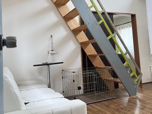 a living room with a staircase and a white couch at Casa Allegra in Yamanakako