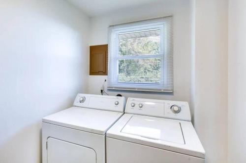 a washing machine in a white room with a window at NEW 3 BR Vacation House Close to Golden Nugget in Atlantic City