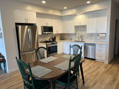 a kitchen with a table and chairs and a refrigerator at Urban SLO Living- 1 mile from downtown in San Luis Obispo